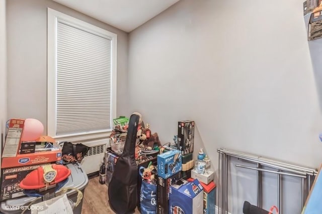 interior space with radiator heating unit and wood finished floors