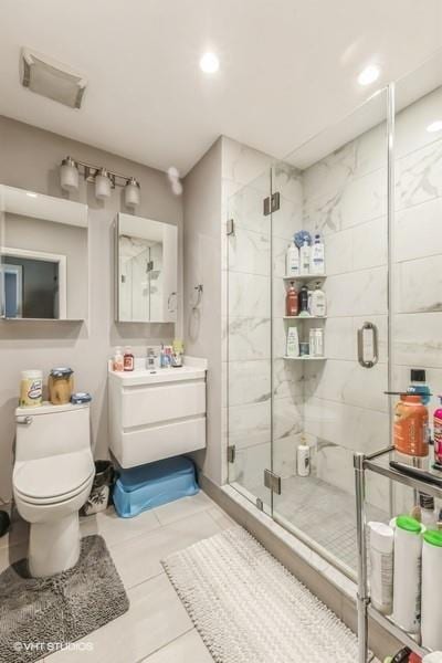 full bath with recessed lighting, tile patterned floors, toilet, vanity, and a stall shower