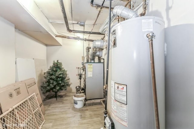 utility room with gas water heater and a heating unit