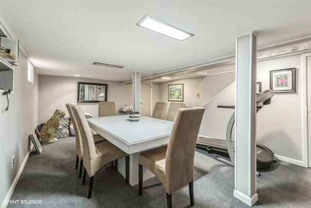 carpeted dining room featuring baseboards