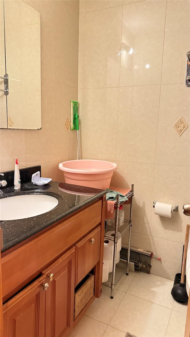 bathroom featuring tile walls, tile patterned floors, and vanity