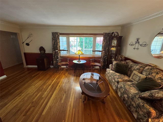 living area with crown molding, wood finished floors, and a wealth of natural light