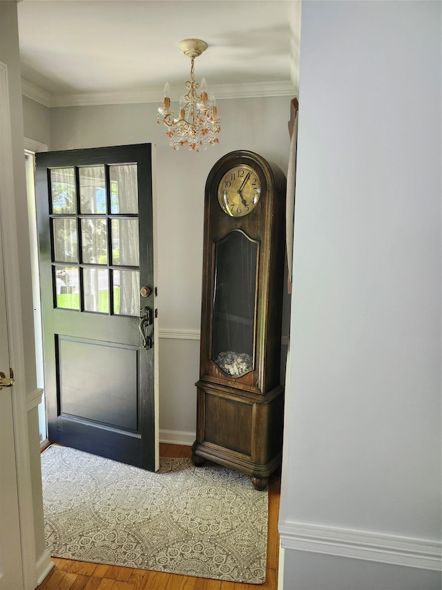 2575 Oaklawn Ave, Southold, NY 11971 - entryway featuring a chandelier, wood finished floors, and ornamental molding