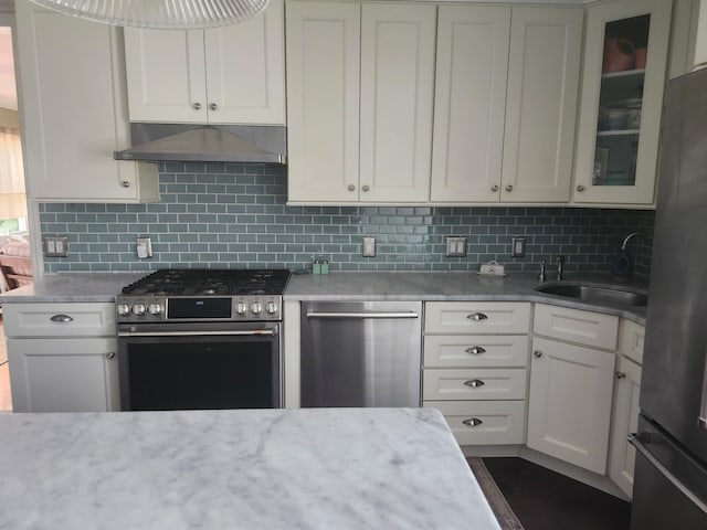 2575 Oaklawn Ave, Southold, NY 11971 - kitchen featuring stainless steel appliances, under cabinet range hood, a sink, backsplash, and glass insert cabinets