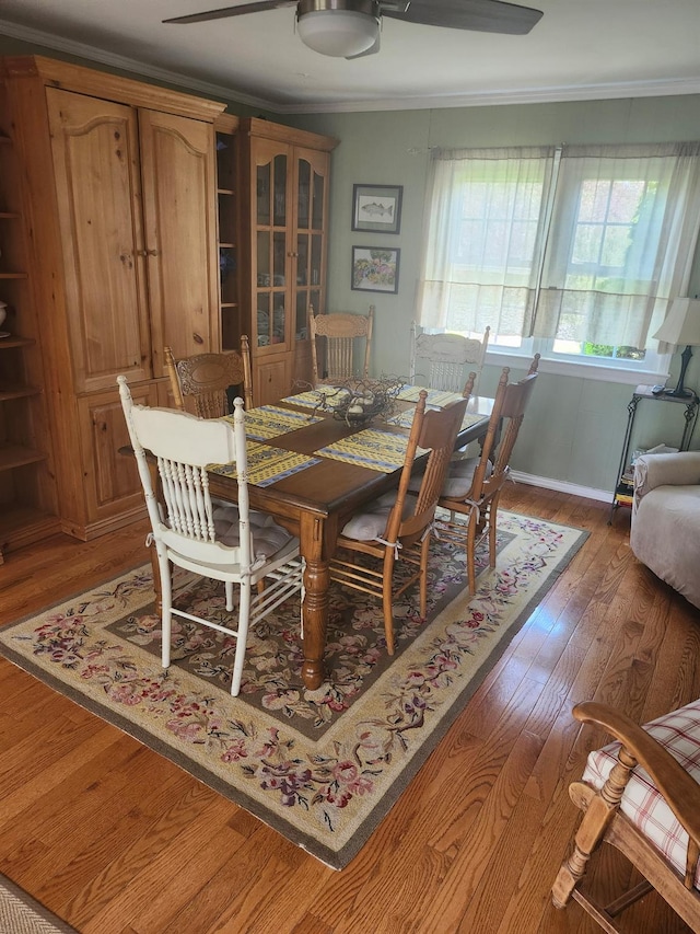 2575 Oaklawn Ave, Southold, NY 11971 - dining area with ornamental molding, wood finished floors, baseboards, and a ceiling fan