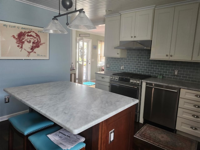 2575 Oaklawn Ave, Southold, NY 11971 - kitchen featuring stainless steel appliances, under cabinet range hood, backsplash, white cabinets, and a center island