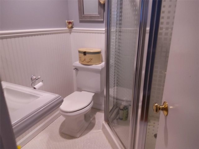 2575 Oaklawn Ave, Southold, NY 11971 - full bathroom featuring a shower stall and wainscoting