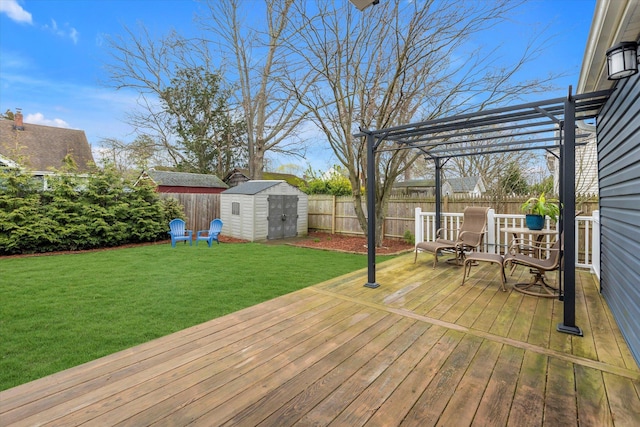 wooden terrace with an outdoor structure, a pergola, a fenced backyard, a storage unit, and a yard