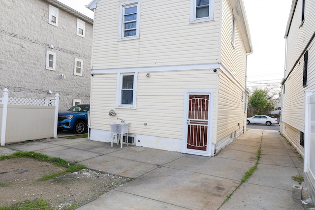 back of house with fence and crawl space