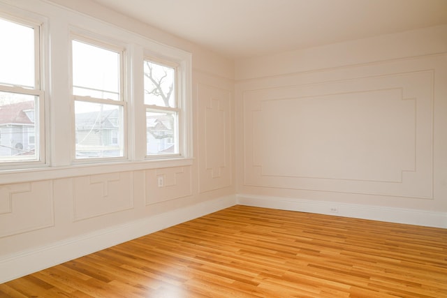 unfurnished room with light wood finished floors