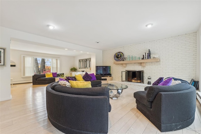 20 Rolling Ridge Rd, New City, NY 10956 - living room featuring a baseboard heating unit, a brick fireplace, light wood-style flooring, and brick wall