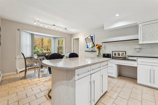 20 Rolling Ridge Rd, New City, NY 10956 - kitchen with decorative backsplash, white cabinets, a center island, a kitchen bar, and recessed lighting