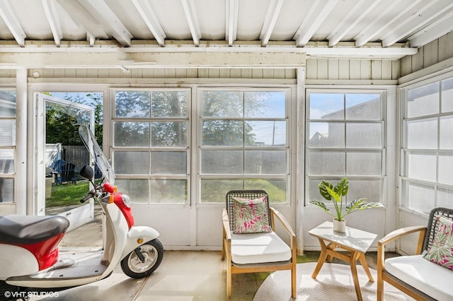 sunroom with plenty of natural light and concrete flooring
