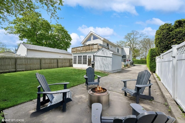 view of patio / terrace featuring an outdoor fire pit and a balcony