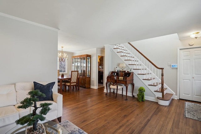 living area featuring crown molding, stairs, wood finished floors, baseboards, and a chandelier