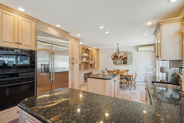 kitchen with light brown cabinets, a kitchen island, a wall mounted air conditioner, stainless steel built in fridge, and a sink