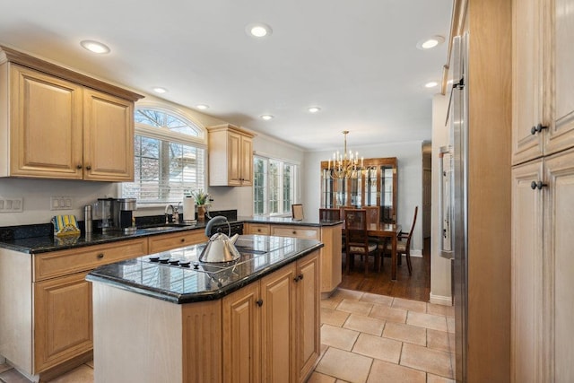 kitchen with an inviting chandelier, a peninsula, a kitchen island, recessed lighting, and black electric cooktop