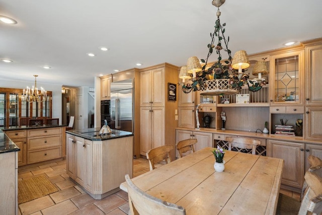 kitchen with a kitchen island, light brown cabinets, recessed lighting, stainless steel built in fridge, and a chandelier