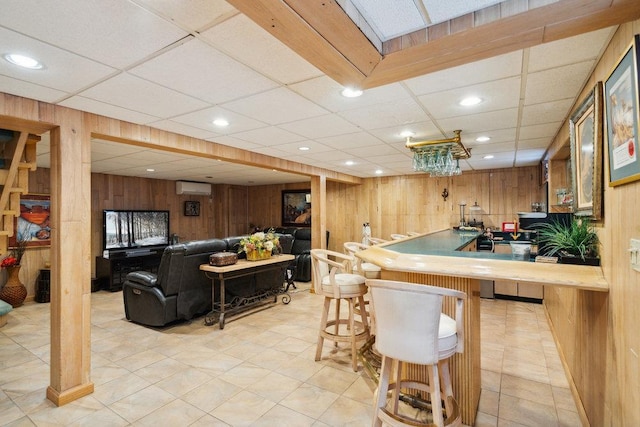 bar featuring recessed lighting, indoor wet bar, an AC wall unit, and wood walls