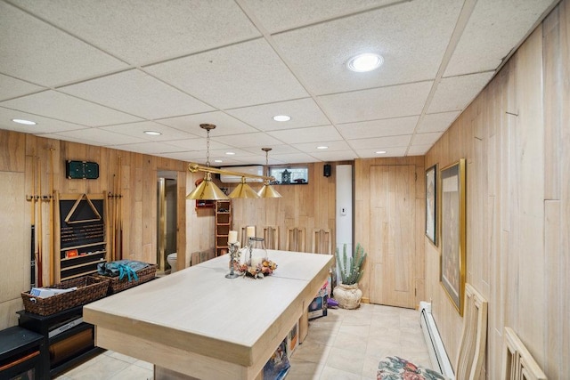 rec room featuring recessed lighting, a baseboard heating unit, wood walls, and a paneled ceiling