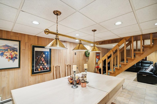 dining area with recessed lighting, wood walls, and a baseboard heating unit