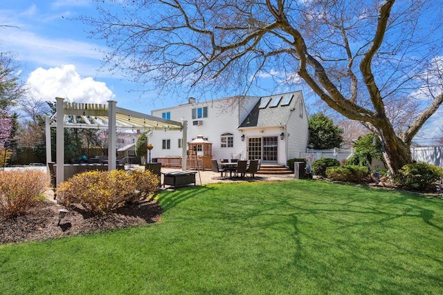 back of house with fence, a pergola, a patio, a chimney, and a lawn