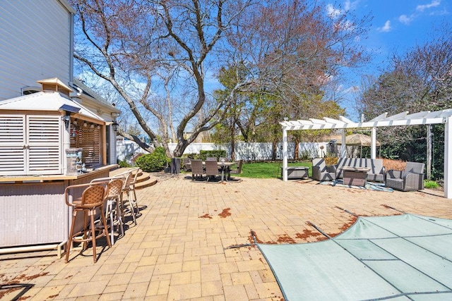 view of patio featuring fence, a pergola, outdoor dry bar, and outdoor dining space