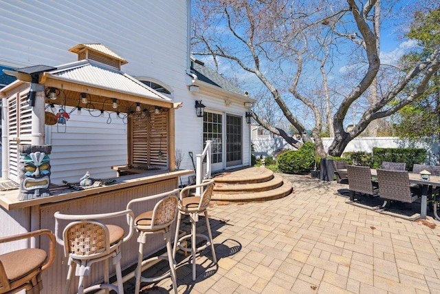 view of patio / terrace featuring fence, outdoor dry bar, and a gazebo