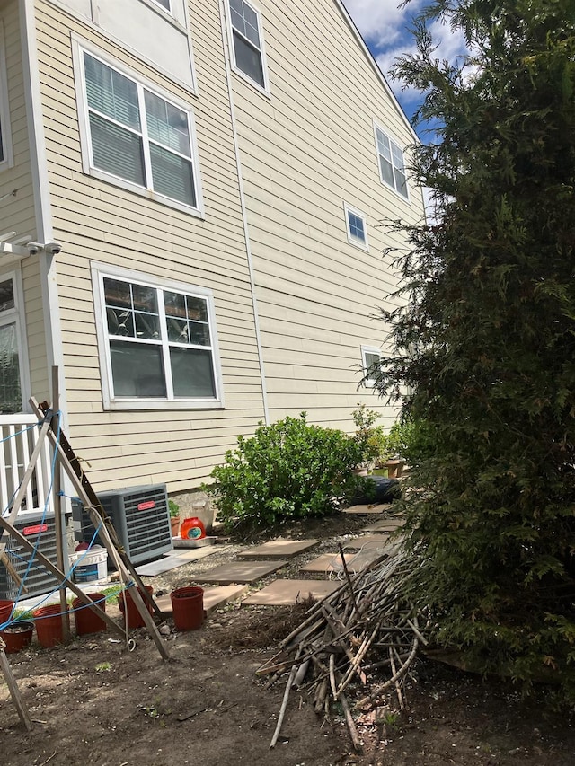 view of property exterior with central AC