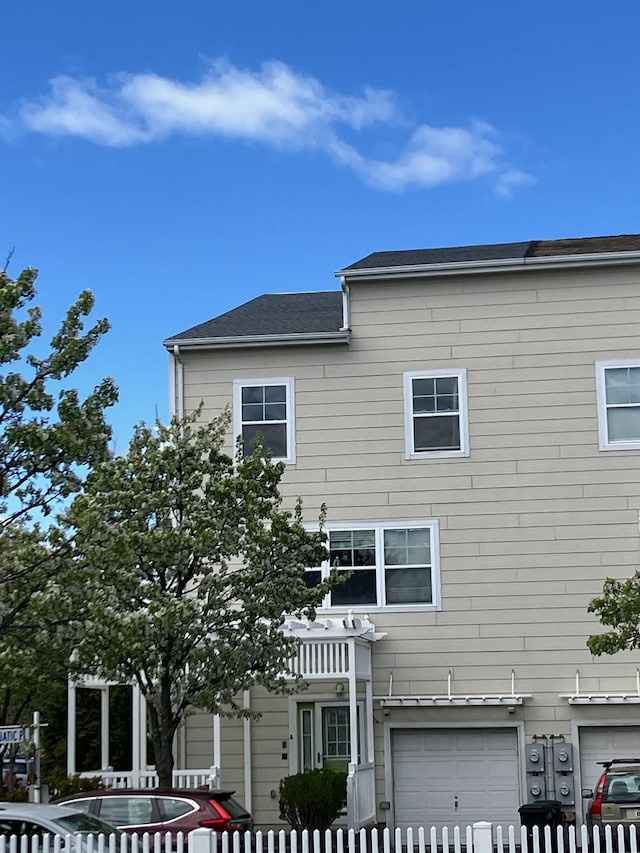exterior space with a garage and fence