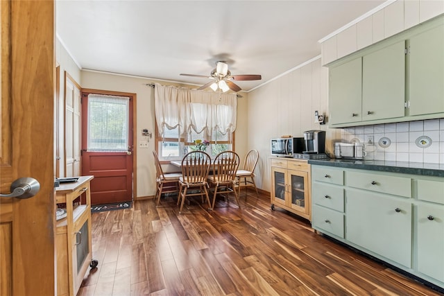 kitchen with dark wood-style flooring, green cabinetry, ornamental molding, and ceiling fan