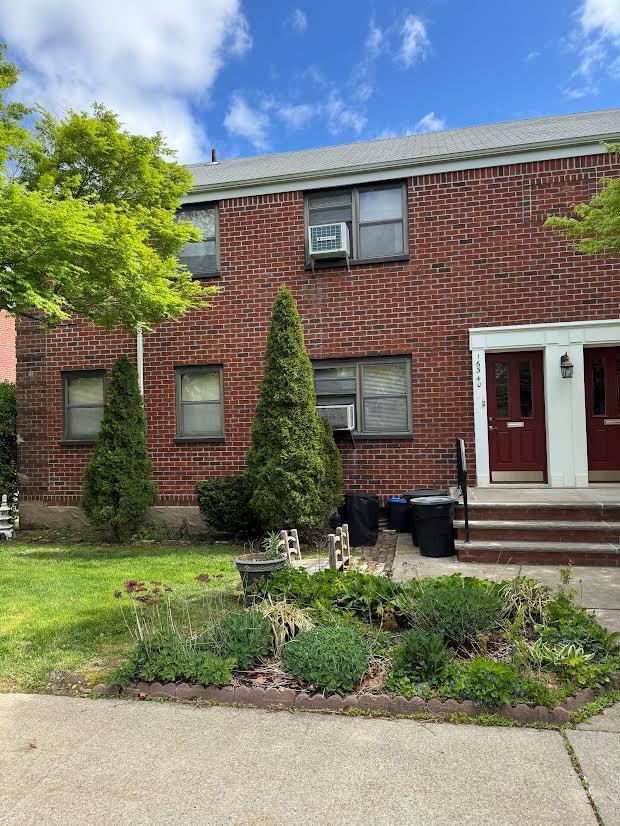 view of property with brick siding