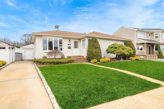 bungalow featuring fence, a gate, roof with shingles, and a front yard