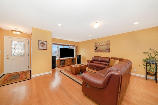living room with light wood-style floors, baseboards, and recessed lighting