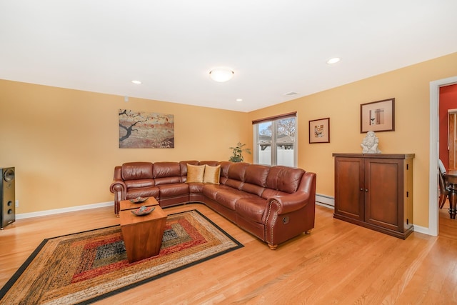 living area with visible vents, baseboards, recessed lighting, a baseboard heating unit, and light wood-style flooring
