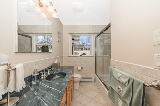 full bathroom with a baseboard heating unit, tile walls, a wealth of natural light, and tile patterned flooring