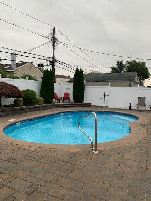 view of pool featuring a fenced backyard, a fenced in pool, and a patio area