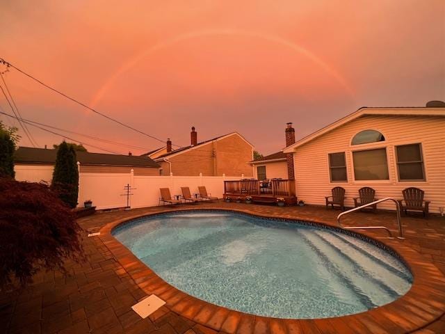 view of pool featuring a deck, a fenced in pool, fence, and a patio