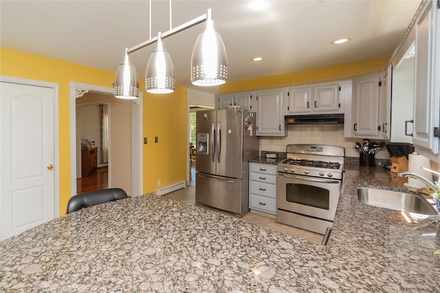 252 Southwoods Dr, Monticello, NY 12701 - kitchen with a sink, stainless steel appliances, stone counters, a baseboard radiator, and under cabinet range hood