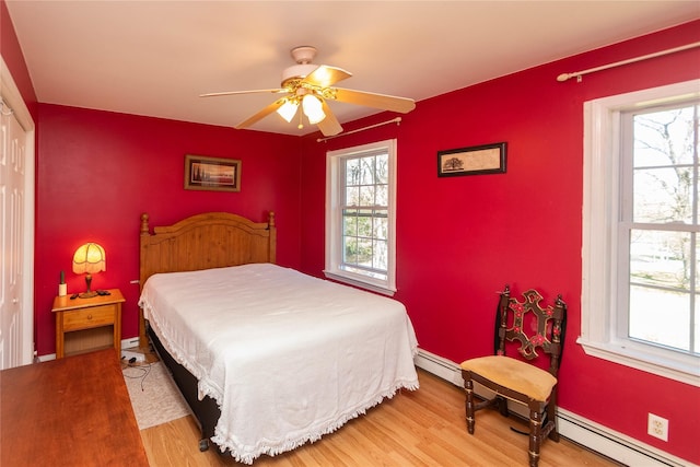252 Southwoods Dr, Monticello, NY 12701 - bedroom featuring a ceiling fan, wood finished floors, and a baseboard radiator
