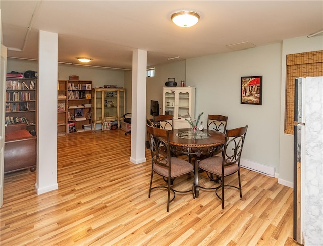 252 Southwoods Dr, Monticello, NY 12701 - dining room with baseboards, a baseboard heating unit, and light wood finished floors