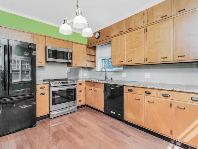 kitchen featuring light wood-style floors, black appliances, and tasteful backsplash