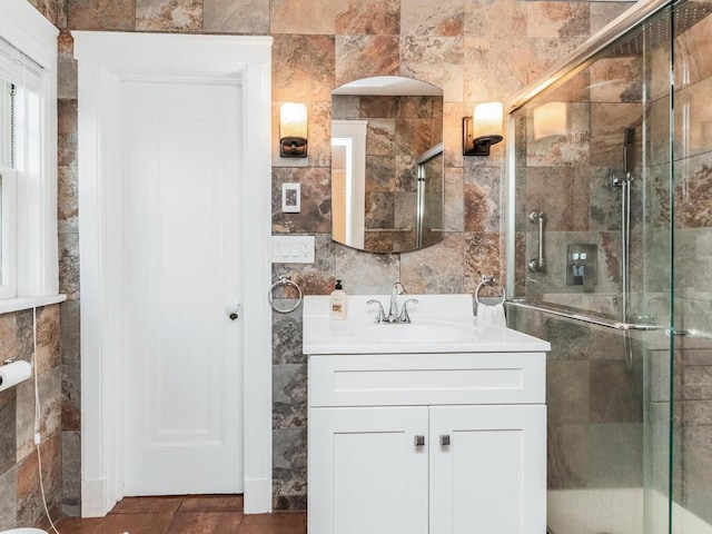 bathroom featuring vanity, tile walls, and a stall shower