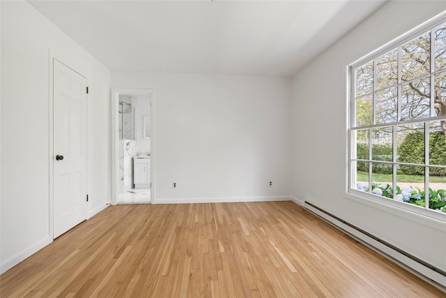 96 Audubon Ave, Bridgehampton, NY 11932 - unfurnished bedroom featuring connected bathroom, light wood-type flooring, baseboards, and baseboard heating