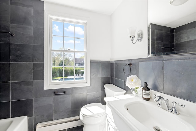 96 Audubon Ave, Bridgehampton, NY 11932 - full bathroom featuring a sink, tile walls, plenty of natural light, and a baseboard heating unit