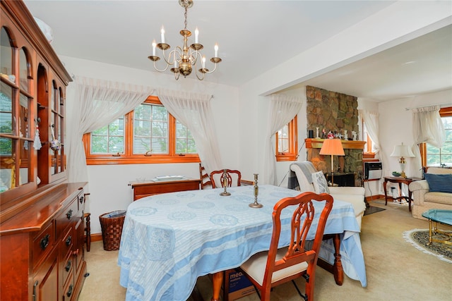 249Slosson Ave, Staten Island, NY 10314 - dining space with a fireplace, a chandelier, light carpet, and baseboards