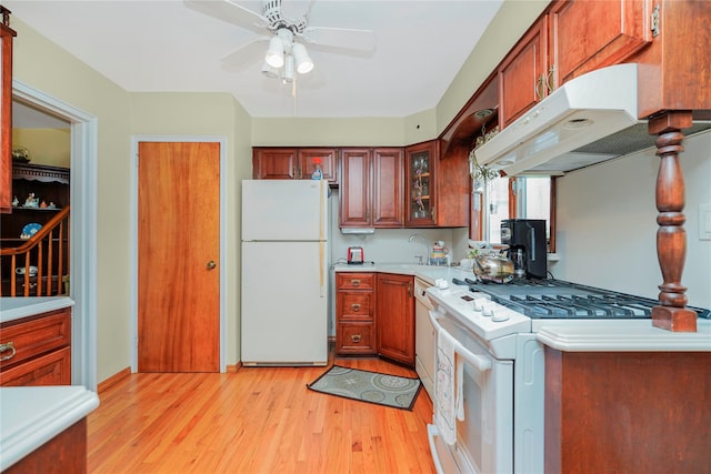 249Slosson Ave, Staten Island, NY 10314 - kitchen with white appliances, under cabinet range hood, light countertops, a ceiling fan, and light wood-style floors