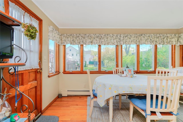 249Slosson Ave, Staten Island, NY 10314 - dining space with a baseboard radiator, crown molding, plenty of natural light, and wood finished floors