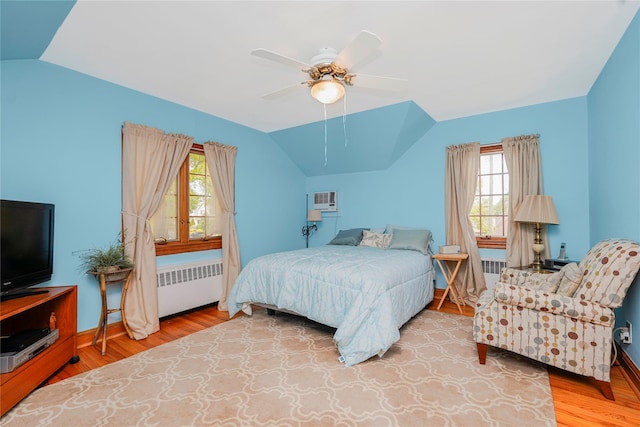 249Slosson Ave, Staten Island, NY 10314 - bedroom with radiator, multiple windows, vaulted ceiling, and wood finished floors