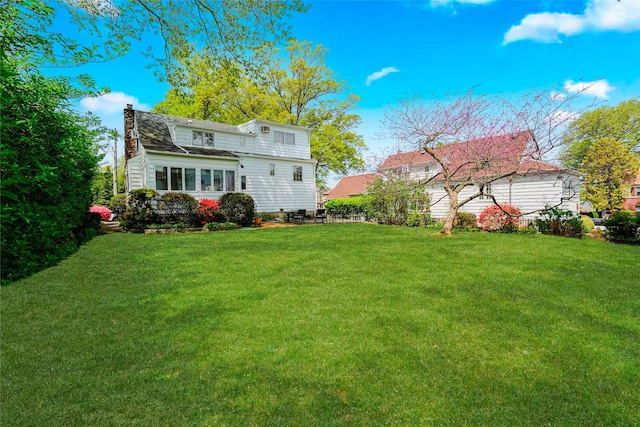 249Slosson Ave, Staten Island, NY 10314 - rear view of property with a lawn and a chimney